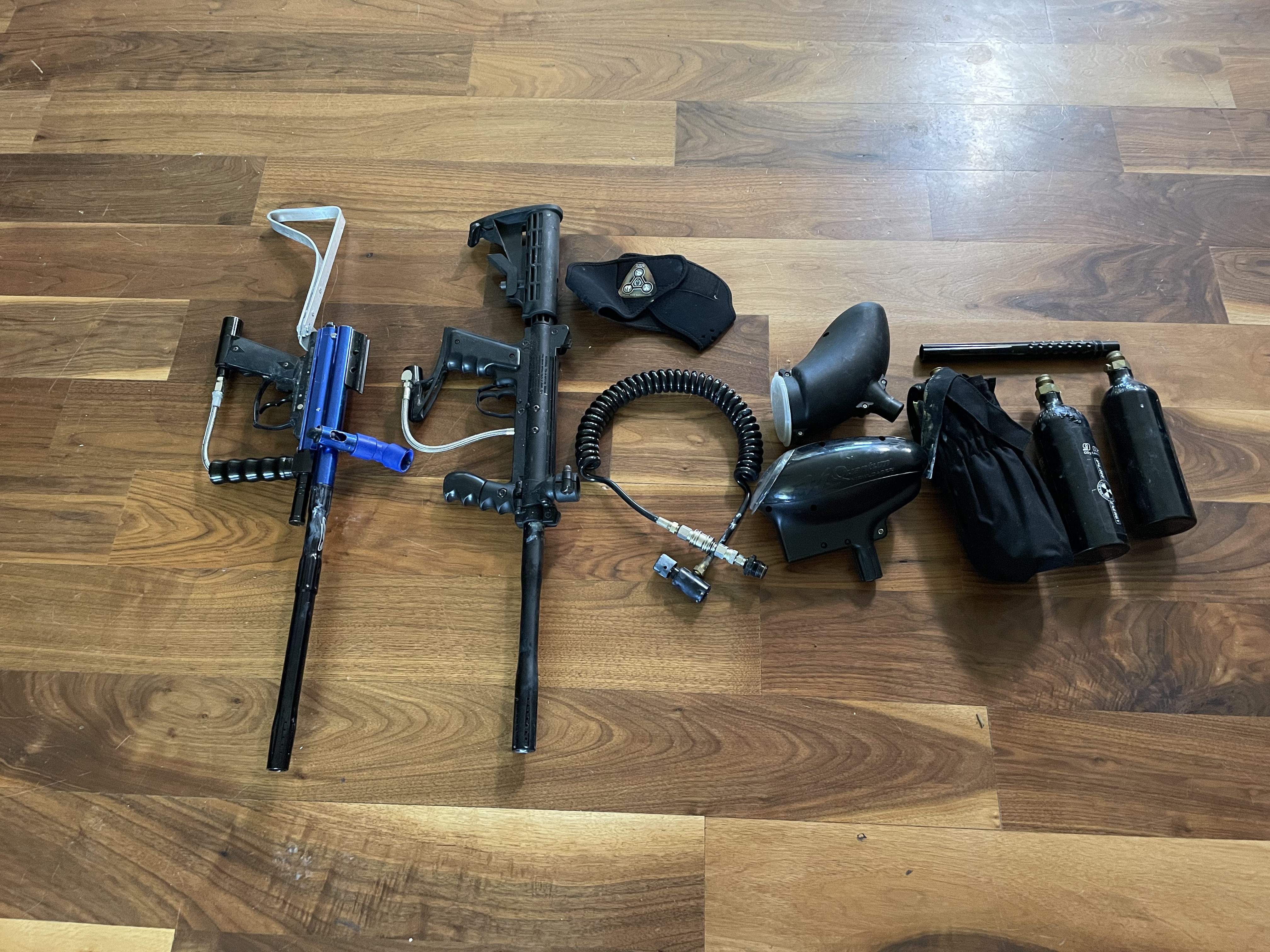 2 paintball markers including a Tippman custom pro and 3 co2 tanks and 2 loaders