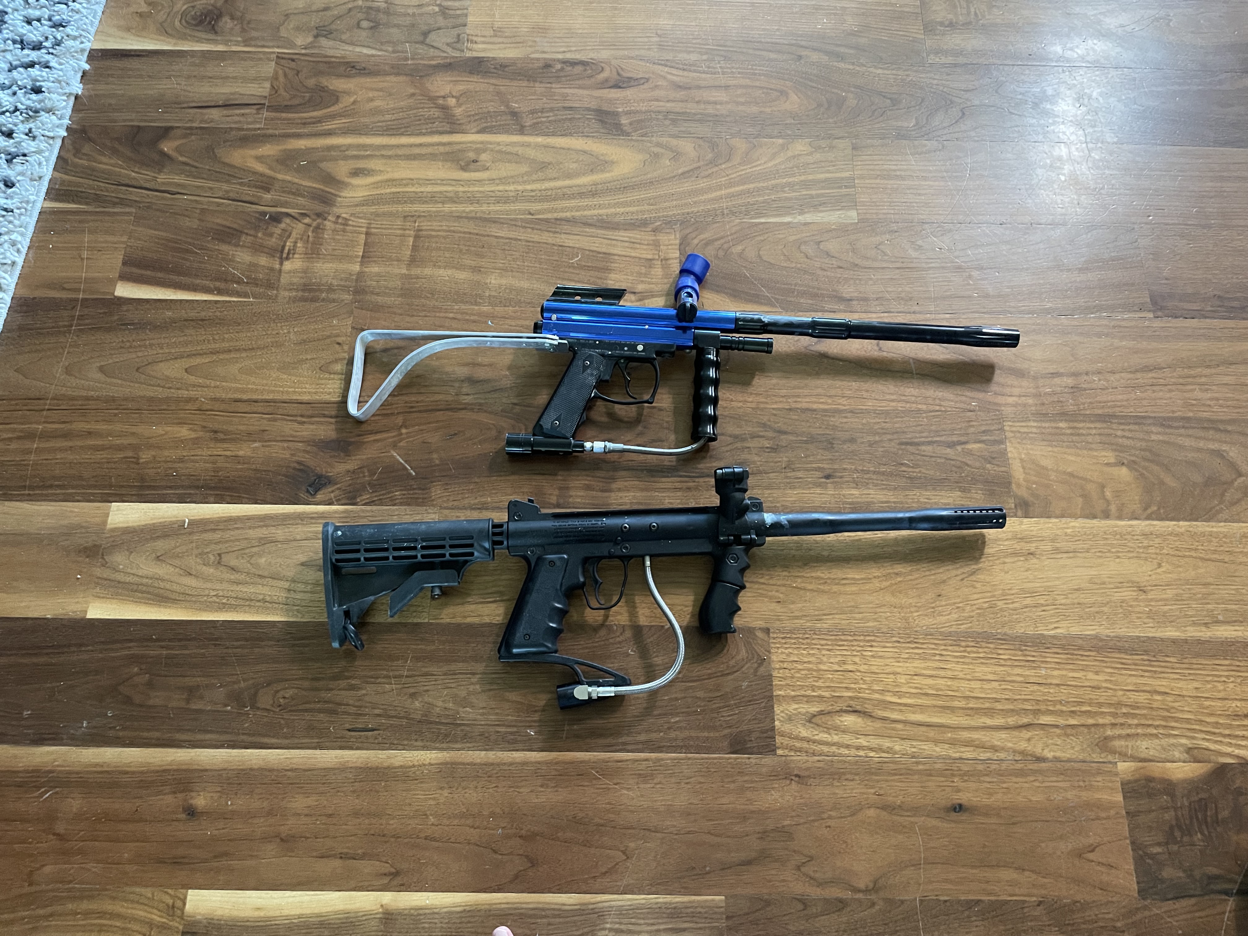 2 paintball markers including a Tippman custom pro and 3 co2 tanks and 2 loaders