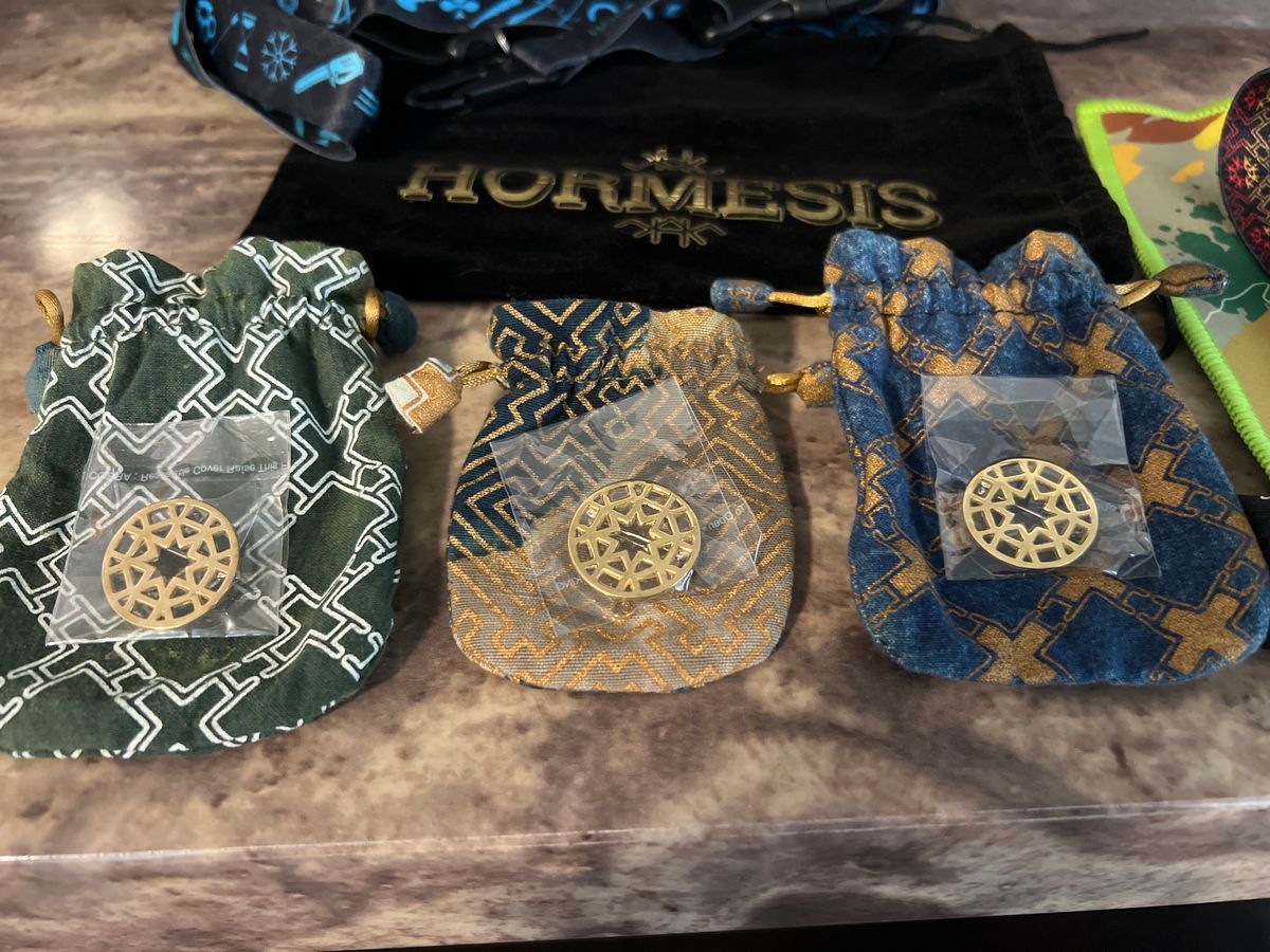 HORMESIS 7 wristbands, 1 black Velvet headband bag, 3 Hormesis pins & 3 Pouches, 1 Micro fiber. 