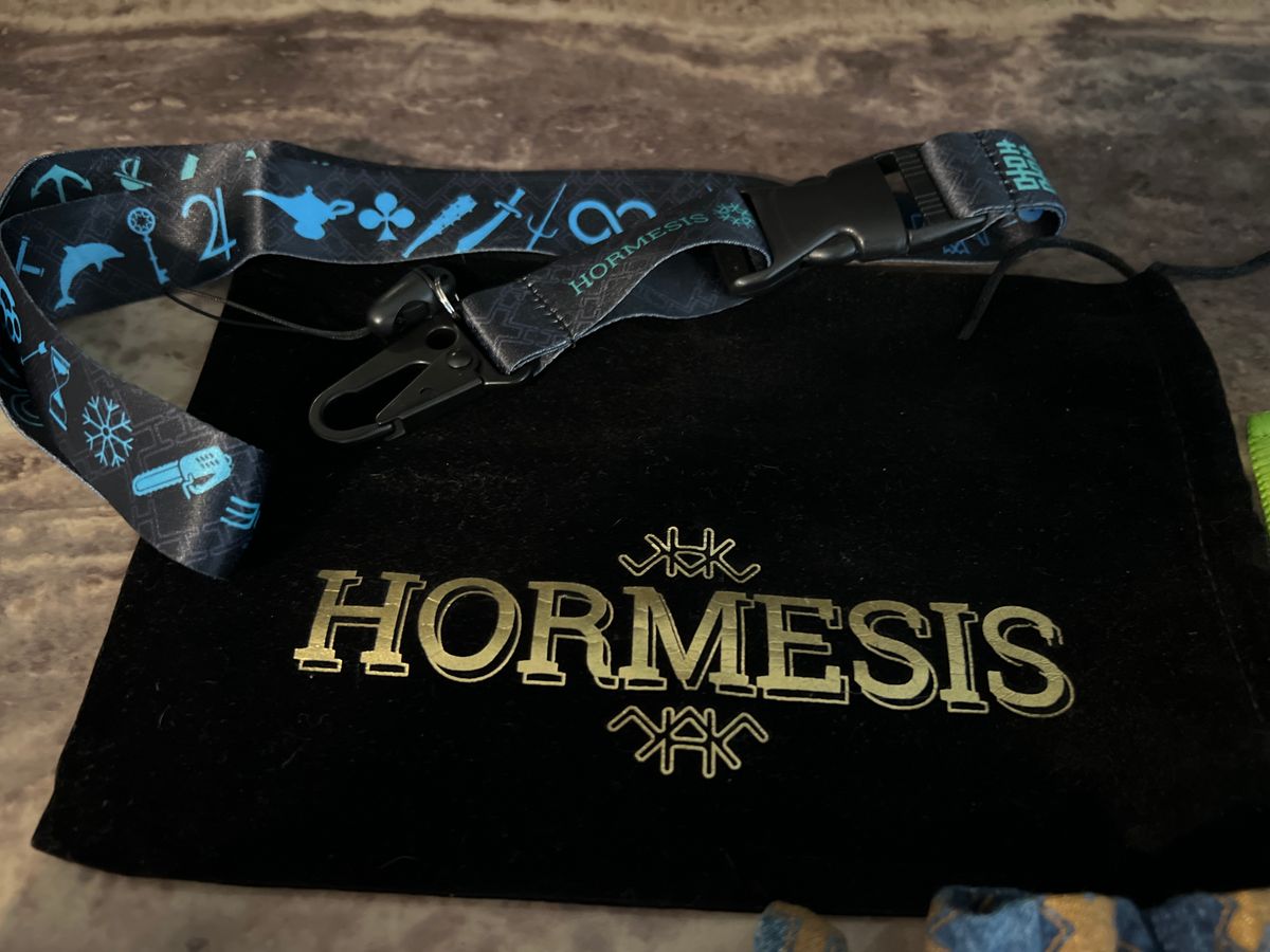 HORMESIS 7 wristbands, 1 black Velvet headband bag, 3 Hormesis pins & 3 Pouches, 1 Micro fiber. 