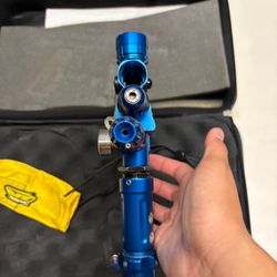 blue custom-milled Worr game product(WGP) Autococker-style paintball marker features an aftermarket vertical feedneck, an Empire pneumatic ram, and a WGP-style frame.