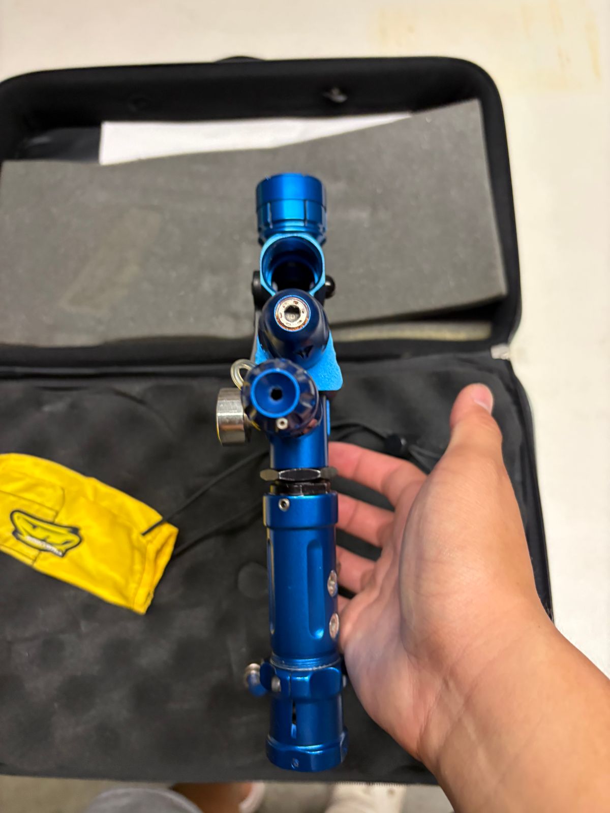 blue custom-milled Worr game product(WGP) Autococker-style paintball marker features an aftermarket vertical feedneck, an Empire pneumatic ram, and a WGP-style frame.