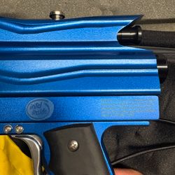 blue custom-milled Worr game product(WGP) Autococker-style paintball marker features an aftermarket vertical feedneck, an Empire pneumatic ram, and a WGP-style frame.