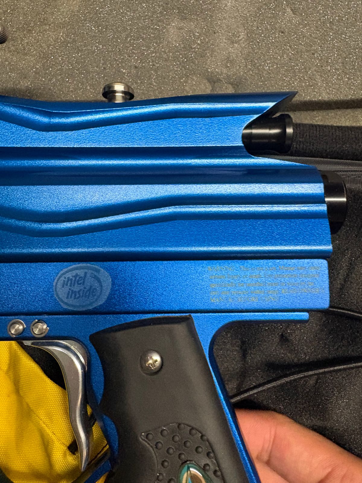 blue custom-milled Worr game product(WGP) Autococker-style paintball marker features an aftermarket vertical feedneck, an Empire pneumatic ram, and a WGP-style frame.