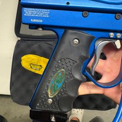 blue custom-milled Worr game product(WGP) Autococker-style paintball marker features an aftermarket vertical feedneck, an Empire pneumatic ram, and a WGP-style frame.