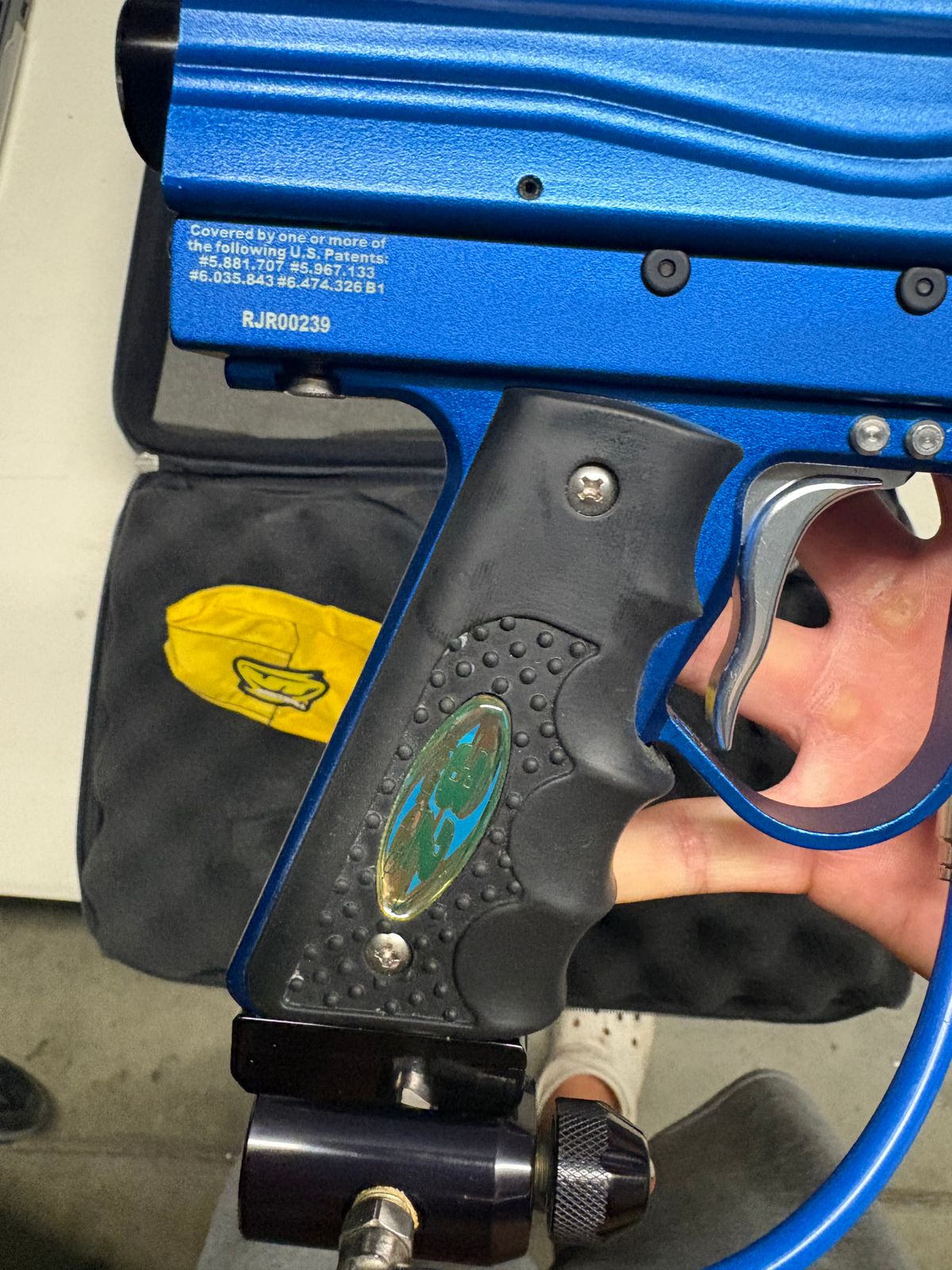 blue custom-milled Worr game product(WGP) Autococker-style paintball marker features an aftermarket vertical feedneck, an Empire pneumatic ram, and a WGP-style frame.