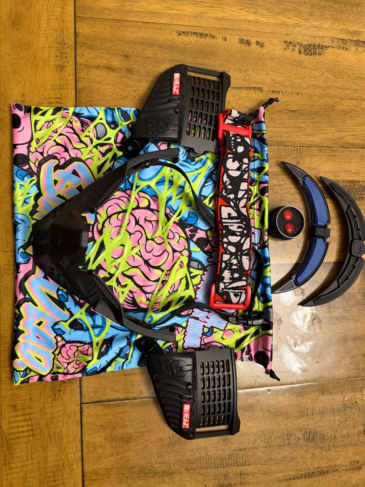 Black subrazed bottoms/ ears/ rain lid / strap. And biscuit red plugs