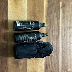2 paintball markers including a Tippman custom pro and 3 co2 tanks and 2 loaders