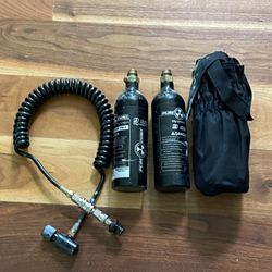 2 paintball markers including a Tippman custom pro and 3 co2 tanks and 2 loaders