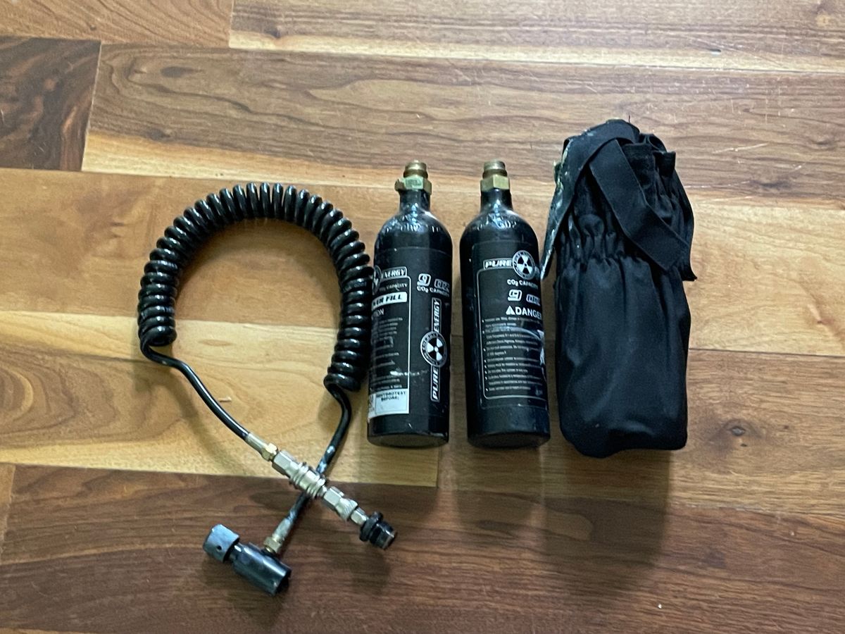 2 paintball markers including a Tippman custom pro and 3 co2 tanks and 2 loaders