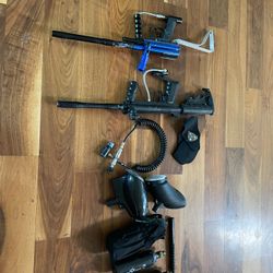 2 paintball markers including a Tippman custom pro and 3 co2 tanks and 2 loaders