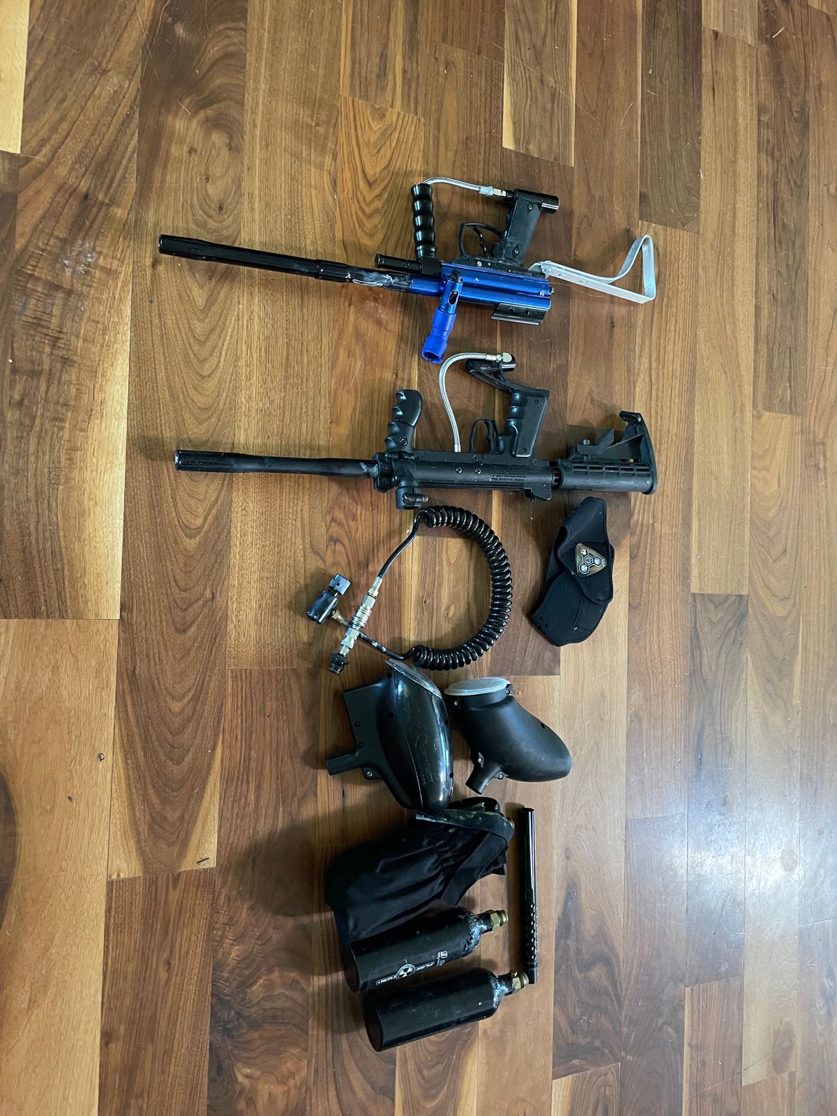 2 paintball markers including a Tippman custom pro and 3 co2 tanks and 2 loaders