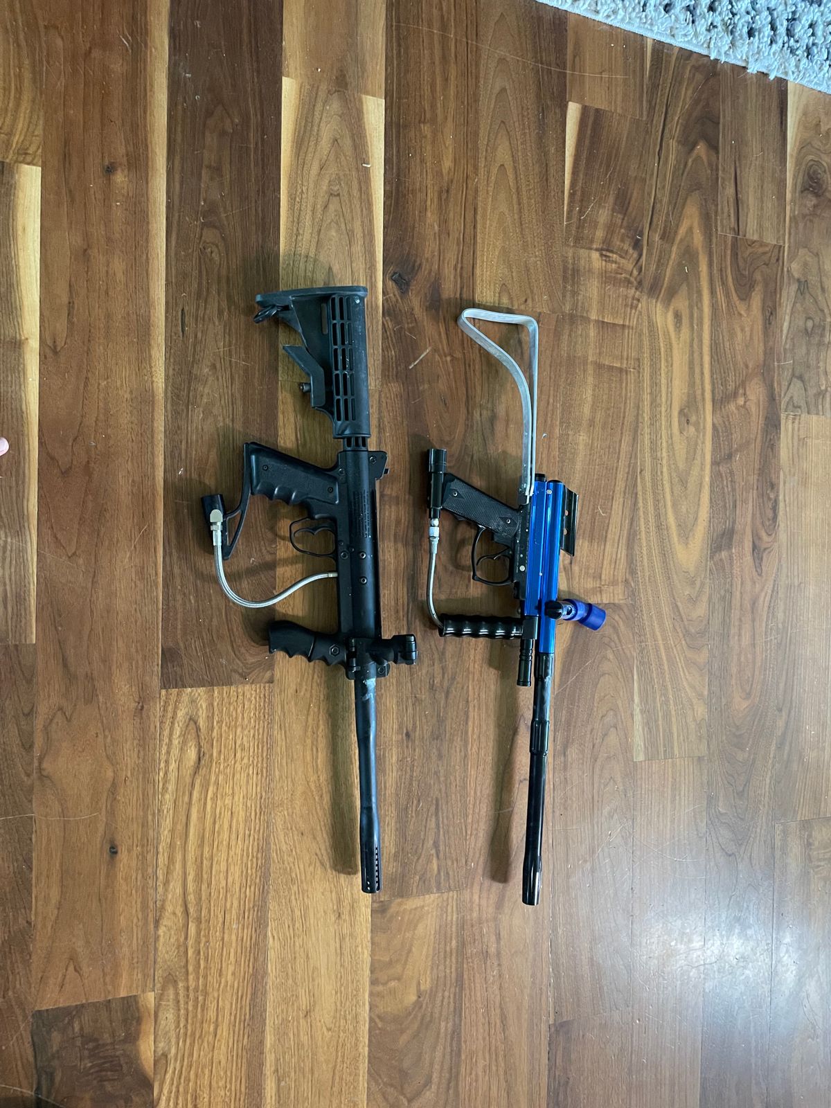 2 paintball markers including a Tippman custom pro and 3 co2 tanks and 2 loaders